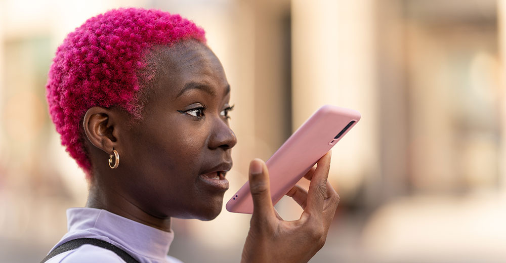 young woman speaking into a smartphone